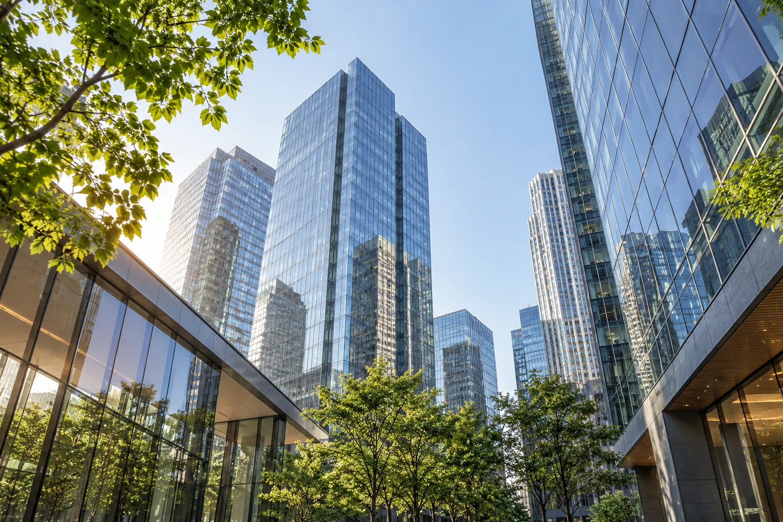 Modern glass office architecture reaching toward an open sky